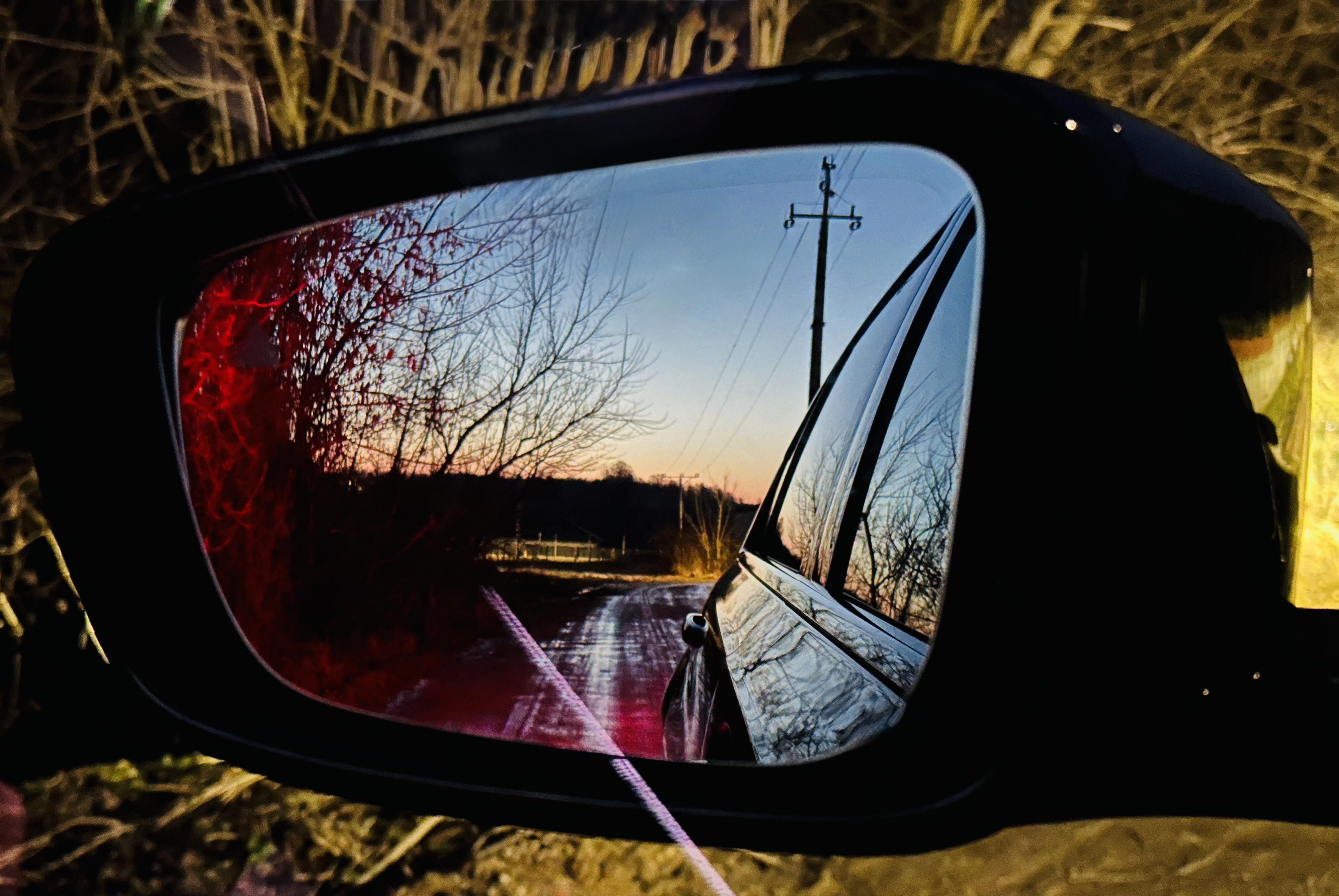 Reflection in a car side mirror